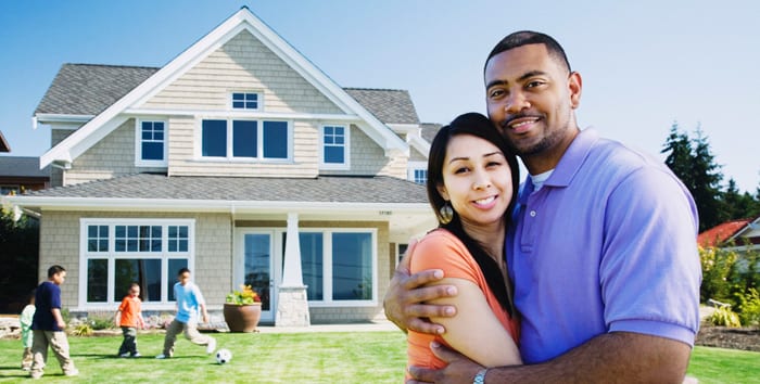 Happy family in front of the house