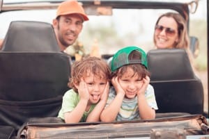 Family in car driving to vacation