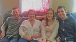 Kim Smith family sitting on sofa