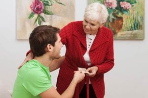 Senior giving money to adult child