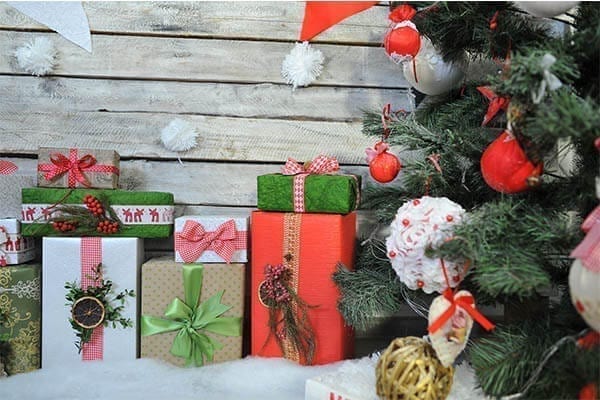 Christmas presents sitting under a Christmas tree