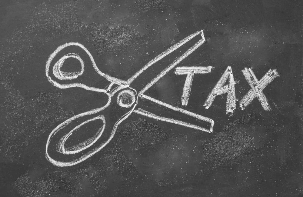 blackboard drawing shows one scissors cut taxes