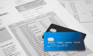 Credit cards lying on top of credit card statement papers