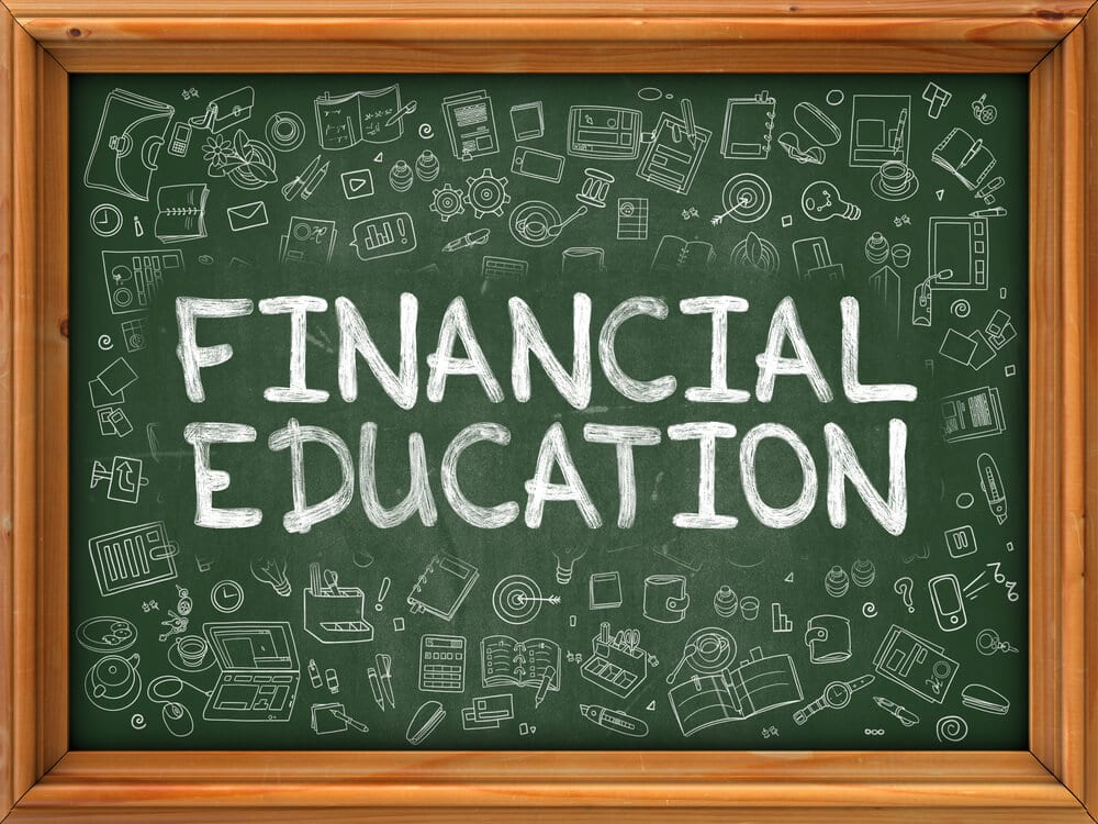 Financial Education hand drawn on chalkboard with doodle icons around.