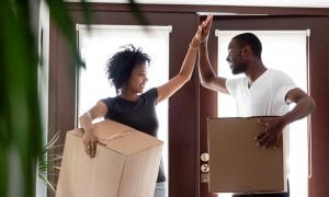 Couple celebrating their new home purchase while moving in