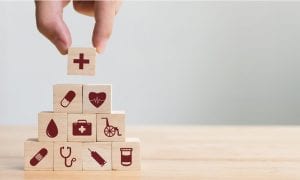 Wooden block pyramid with healthcare icons on each block