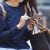 Woman carrying shopping bags using her phone to buy items now and pay later