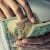 Hands counting extra income earned from a side job