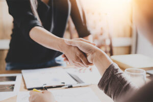 Borrower negotiating with a creditor and shaking hands