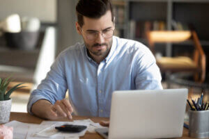 Man calculating how much to spend on rent