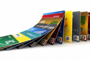 A stack of credit cards toppling each other over like dominos