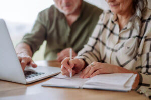 Senior citizen couple researching bankruptcy options online
