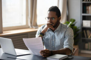 Man on computer searching for his debts