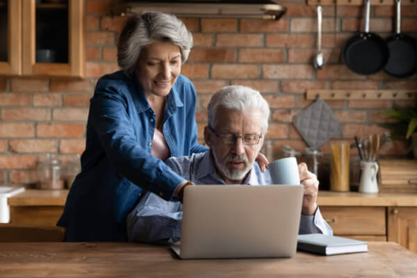 Elderly couple on computer looking for a loan