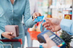 Woman swiping her credit card at the store