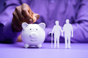 Man putting coins in piggy bank savings