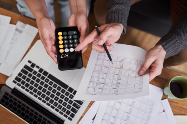 A couple calculating their budget together