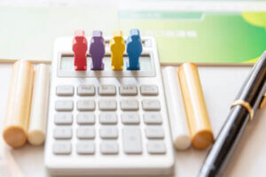 Figurines and a calculator representing inheriting debt.