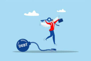 Businessman holding golden key after unlock debt burden chain.