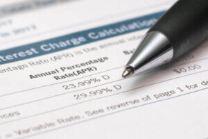 Close Up Of Pen And Bank Statements Showing Credit Card APR.