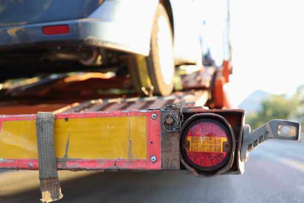 Car on tow truck representing repossession