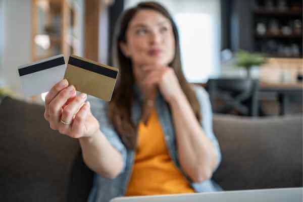 Woman with two credit cards in her hand representing best balance transfer card