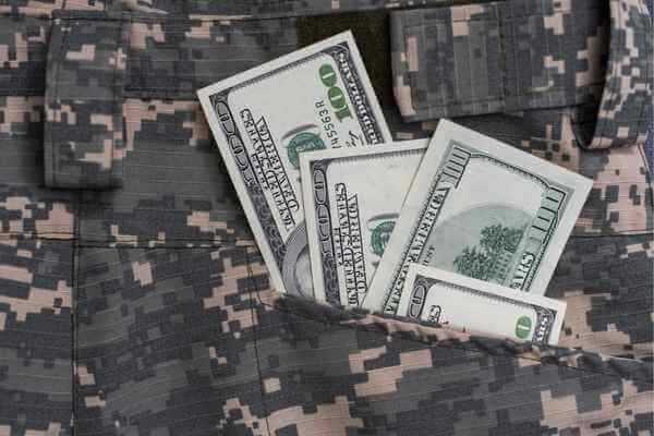 U.S. dollar bills on a military uniform pocket representing military banking.