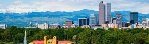 Denver Colorado downtown with City Park, tall buildings and mountains in background