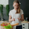 Woman looking at receipt showing more expensive grocery items after inflation