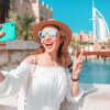 Woman on social media encouraging bad spending habits while on vacation